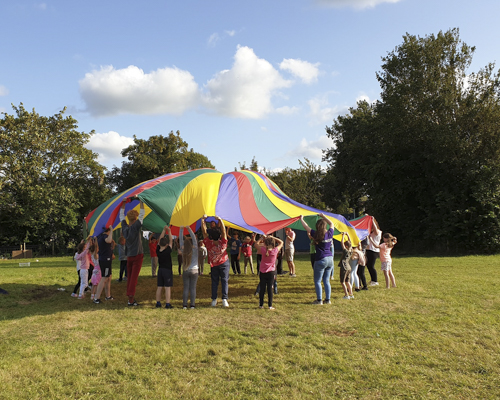 Children attempting to put up a gazebo